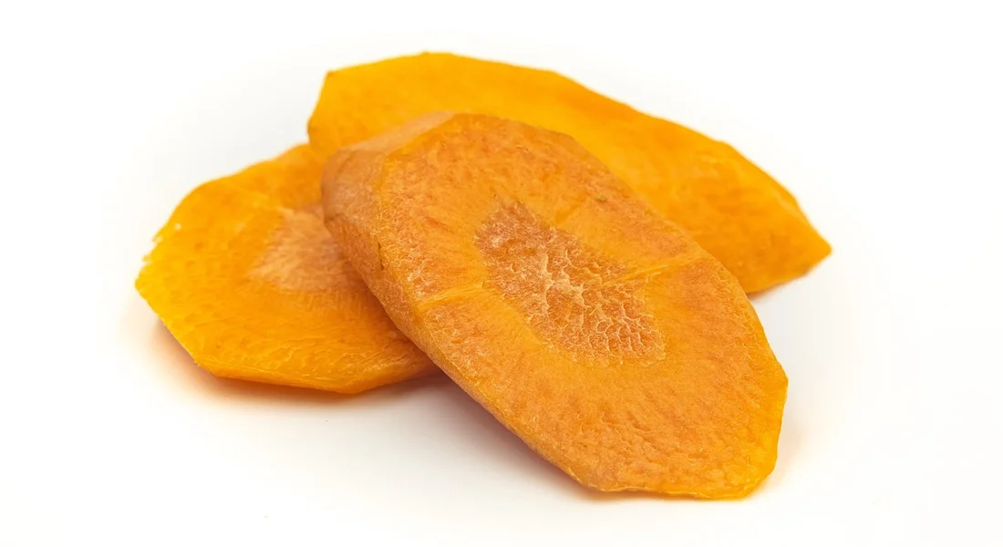 Two dried orange slices on a white background.