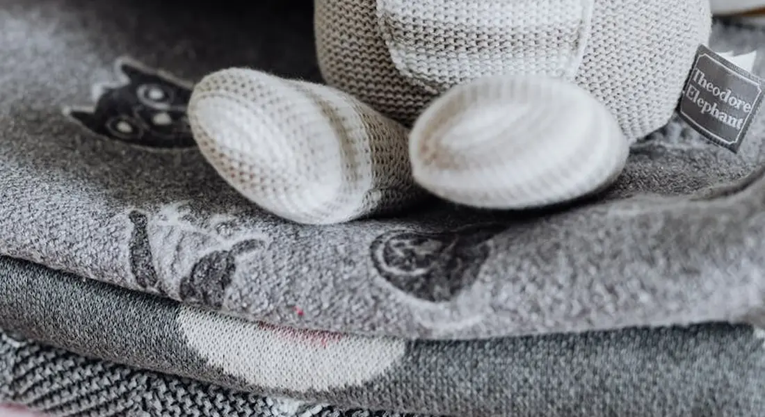 Close-up of soft, reusable fleece liners and folded fabric bedding, highlighting textures and care requirements