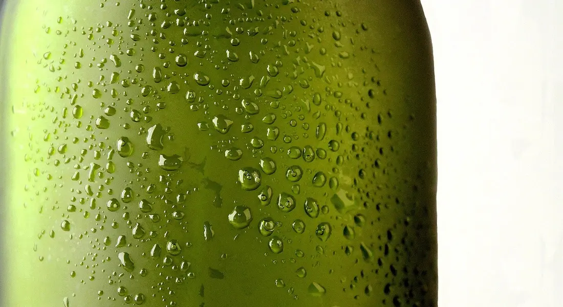 Close-up of a green water bottle with condensation droplets