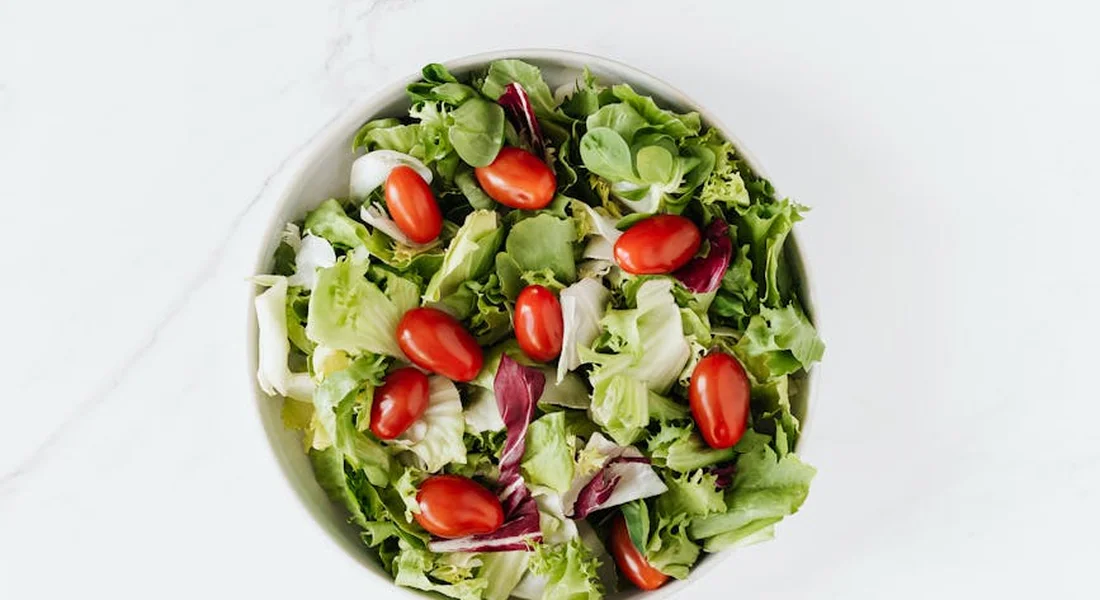 Bowl of mixed greens with cherry tomatoes
