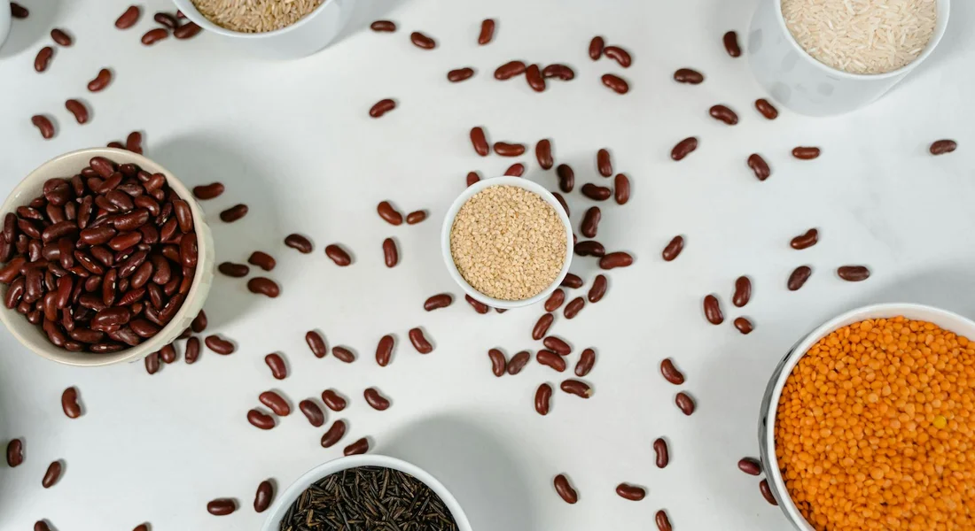 Top-down view of several bowls filled with guinea pig food and scattered seeds on a clean surface, highlighting easy-to-clean bowls.