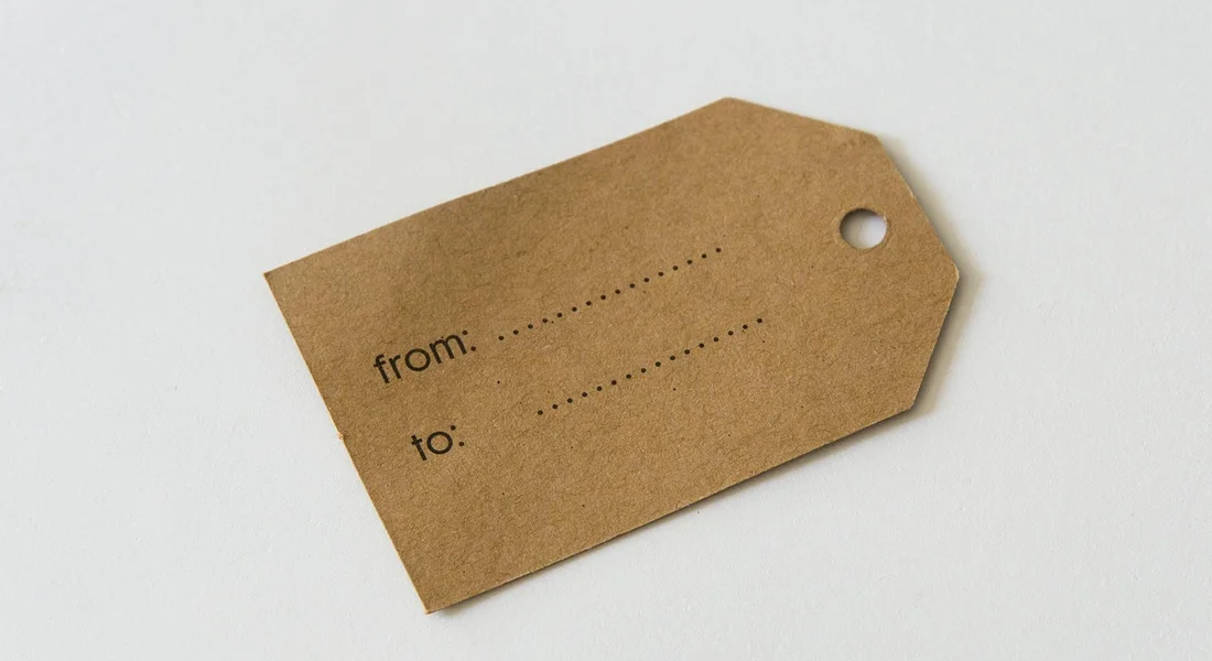 Brown kraft tag on a light background with lines labeled 'from:' and 'to:'