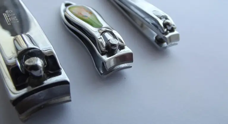 Close-up of metal nail clippers on a light surface, ready for grooming a small pet
