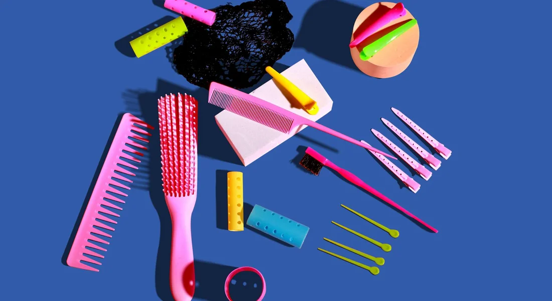 Assorted guinea pig grooming tools on a blue background, including brushes, combs, and nail care items