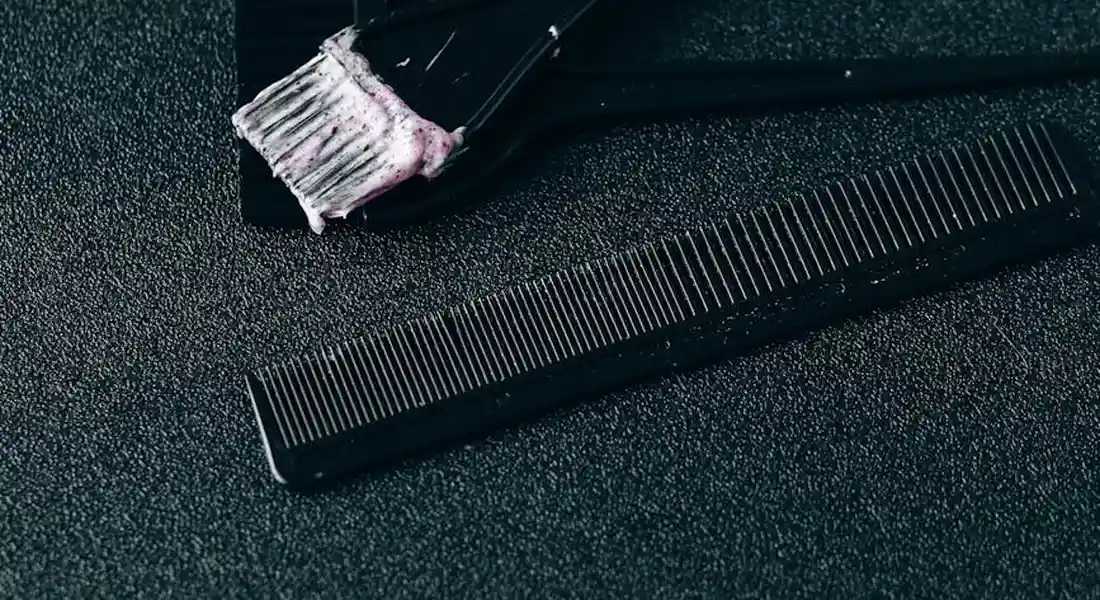 Grooming brushes and combs placed on a dark textured surface, ready for guinea pig grooming
