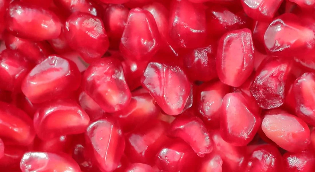 Close-up of bright red pomegranate seeds (arils)